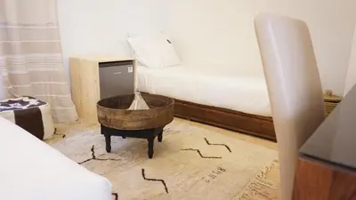a bedroom with a bed and a wooden tub on the floor at RIAD KALE POLIS in Marrakech