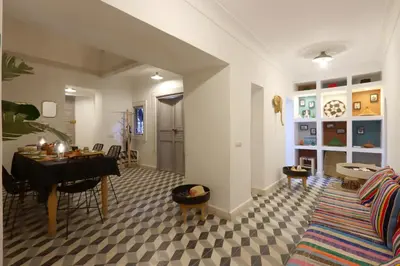 a living room with a table and a dining room at Riad Pop, a haven in the heart of the Medina in Marrakech