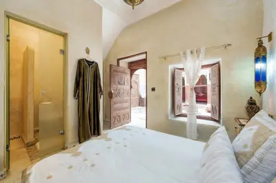 a bedroom with a large white bed in a room at Riad La Fayette Bed & Breakfast in Marrakech