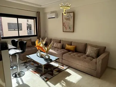 a living room with a couch and a table at Charm Apartment in Marrakech in Marrakech
