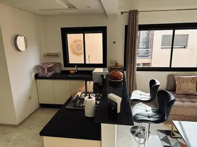 a kitchen with a stove and a counter top at Charm Apartment in Marrakech in Marrakech