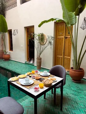 a table with plates of food on top at Riad Citrus By La Siredrah in Marrakech