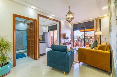 a living room with a couch and a chair at Le Jasmin - Appartement Authentique à Gueliz in Marrakech