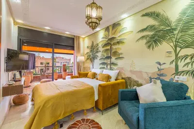 a hotel room with a bed and a couch at Le Jasmin - Appartement Authentique à Gueliz in Marrakech
