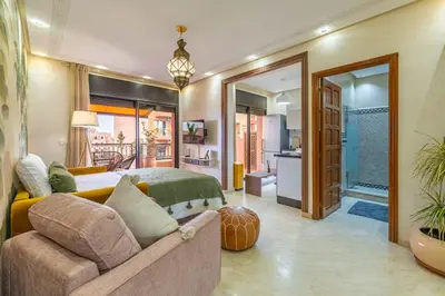 a bedroom with a bed and a couch at L'Atlas - Appartement Authentique à Gueliz in Marrakech