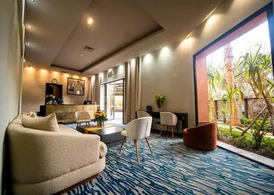 a living room with a couch and a table at Hotel Le Rocher Marrakech in Marrakech