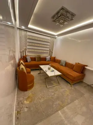 a living room with a couch and a table at Modern-elegant Appartement in het centrum in Marrakech