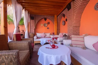 a room with couches and a table in a room at Riad Anais Marrakech in Marrakech