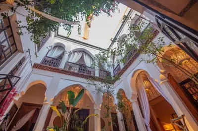 a building in the city of granada with a mural on the wall at Riad Anais Marrakech in Marrakech