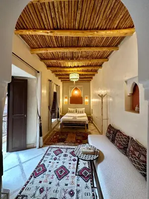 a living room with a bed and a table at Riad Sakura Marrakech in Marrakech