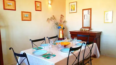 a table with a white table cloth and blue plates on it at Votre appartement d'exception in Marrakech
