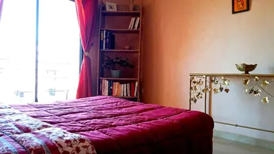 a bedroom with a bed and a book shelf at Votre appartement d'exception in Marrakech