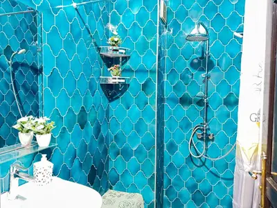 a bathroom with a blue tiled wall at Marrakech art in Marrakech