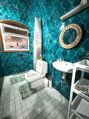 a blue bathroom with a toilet and a sink at Marrakech art in Marrakech