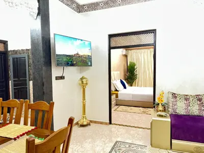 a living room with a bed and a dining room at Marrakech art in Marrakech
