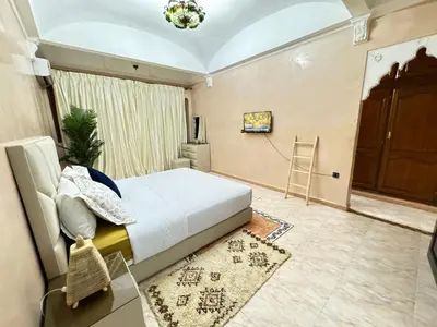 a bedroom with a bed and a chair in it at Marrakech art in Marrakech