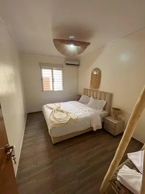 a bedroom with a large bed and a window at NS 36 by Majestic Properties in Marrakech