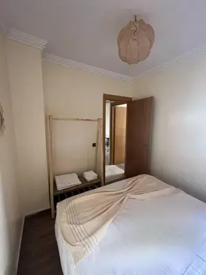 a bedroom with a white bed and a mirror at NS 36 by Majestic Properties in Marrakech