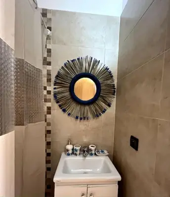 a bathroom with a sink and a mirror on the wall at NS 36 by Majestic Properties in Marrakech