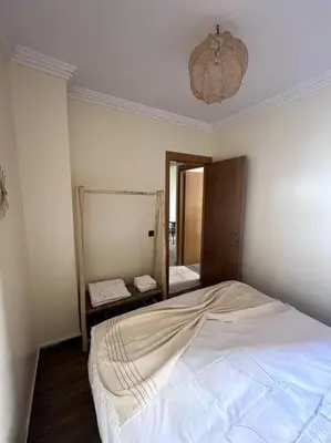 a bedroom with a large white bed with a mirror at NS 36 by Majestic Properties in Marrakech