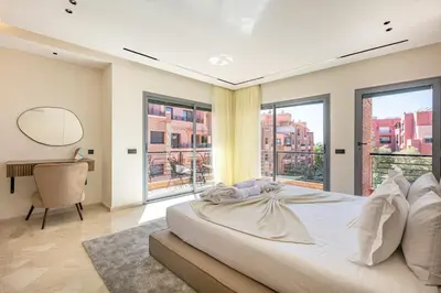 a bedroom with a large bed and a large window at Bohemian Flat in Marrakech