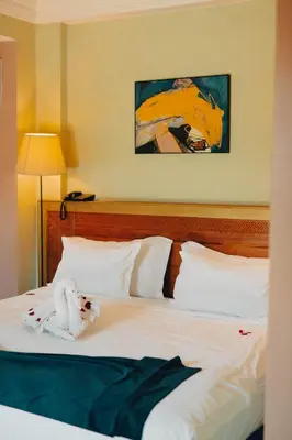 a stuffed animal is sitting on a bed at Palais Jena in Marrakech