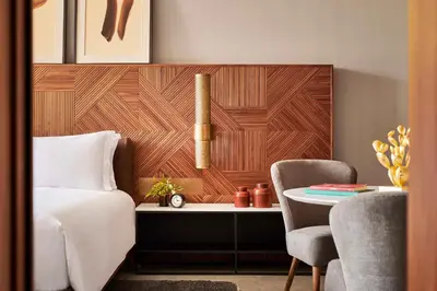 a bedroom with a bed and a desk and a chair at Park Hyatt Marrakech in Marrakech