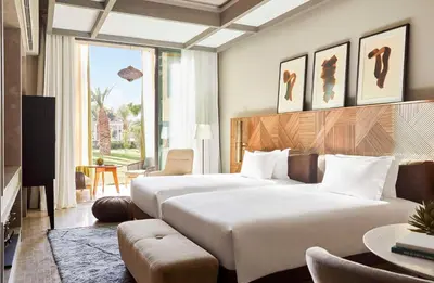 a hotel room with two beds and a television at Park Hyatt Marrakech in Marrakech