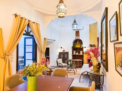 a living room with a table and chairs at Riad Amethyste in Marrakech