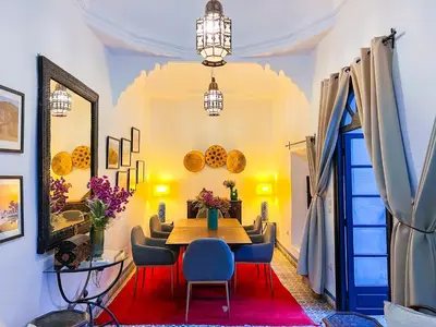 a dining room with a table and chairs at Riad Amethyste in Marrakech