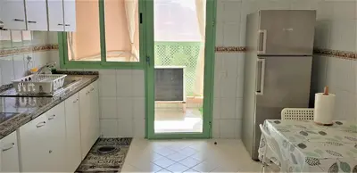 a kitchen with a refrigerator and a table in it at ☆HIVERNAGE☆ Charming , Spacious & Bright with Pool in Marrakech