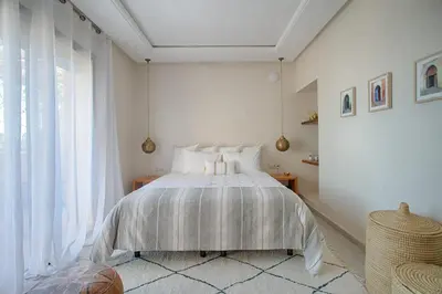 a bedroom with a bed and a large window at L'Orientale By La Siredrah in Marrakech