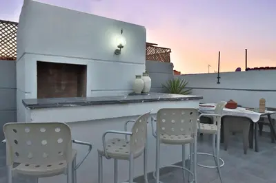 a patio with a bar with chairs and a table at Riad Modern Bed & Breakfast - Top location in Marrakech