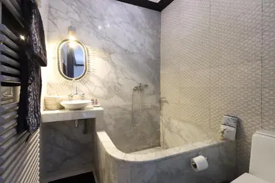a bathroom with a tub and a sink and a shower at Riad Modern Bed & Breakfast - Top location in Marrakech