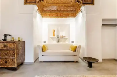 a living room with a white couch and a table at Riad Manzal in Marrakech