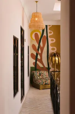a hallway with a couch and a painting on the wall at Riad Pompon in Marrakech