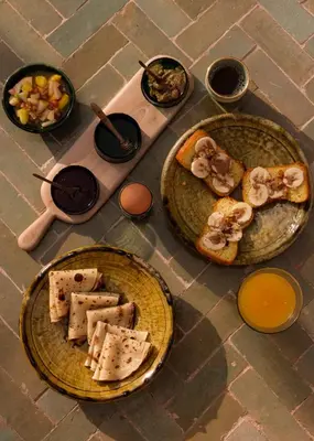 a table with three plates of food on it at Riad Pompon in Marrakech