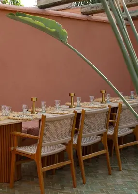 a long table with chairs and glasses on it at Riad Pompon in Marrakech