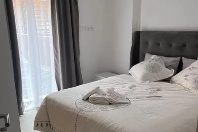 a white bed with a pair of slippers on it at 1Bed Apartment - Sleeps 4 - Balcony Wifi Parking in Marrakech
