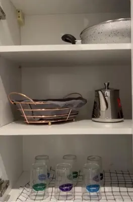 a shelf with glasses and a pot and a mixer at 1Bed Apartment - Sleeps 4 - Balcony Parking Wifi in Marrakech