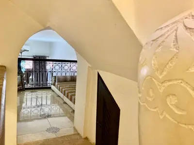 a hallway of a house with a couch and a staircase at MAISON PROCHE DANS LA MEDINA MARRAKECH in Marrakech