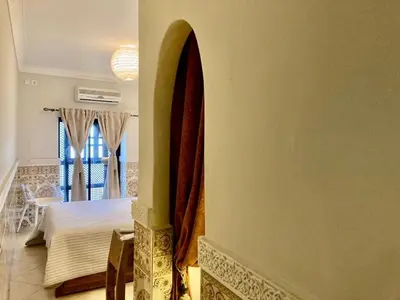 a room with a surfboard hanging on the wall at MAISON PROCHE DANS LA MEDINA MARRAKECH in Marrakech