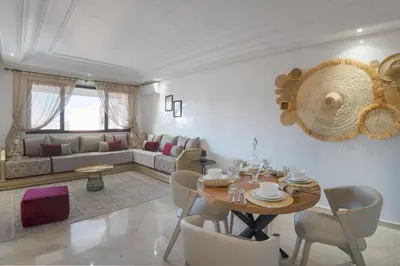 a living room with a table and a couch at Aya Suites in Marrakech