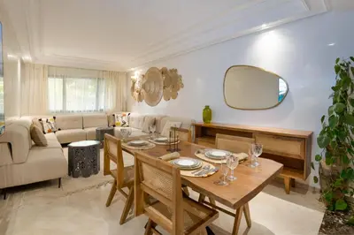 a living room with a table and a couch at Aya Suites in Marrakech