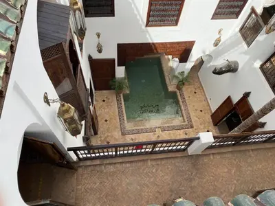 an overhead view of a swimming pool in a building at Ryad Petit Palmier in Marrakech