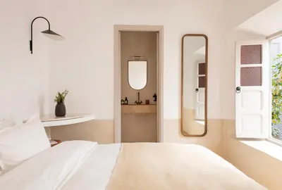 a bedroom with a white bed and a mirror at Riad Brummell Medina in Marrakech