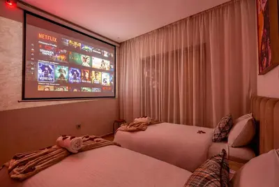 a hotel room with two beds and a flat screen tv at Luxury Apartments Prestigia Pools Golf Fiber Parking in Marrakech