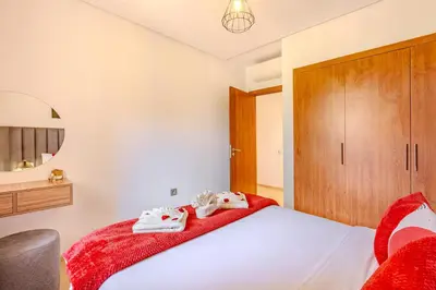 a bedroom with a bed with towels on it at Luxury Apartments Prestigia Pools Golf Fiber Parking in Marrakech