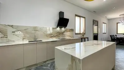 a large kitchen with a marble counter top at Villa AZUR - piscine chauffée sans vis-à-vis à Marrakech in Marrakech
