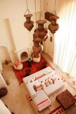 a living room with a bed and a chandelier at Villa Magnolia - Amelkis Golf in Marrakech